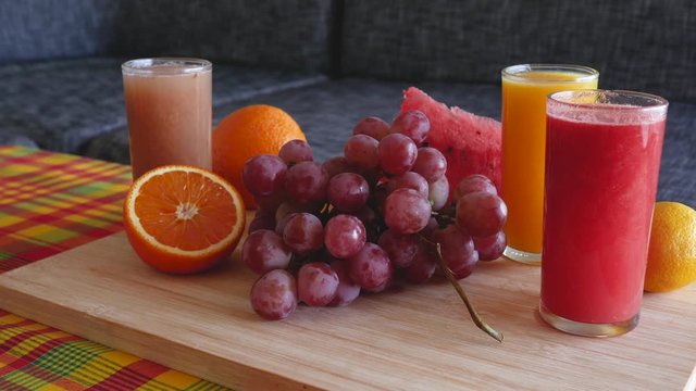 Cinematic 4K "Zoom in" movement on fruit platter containing colorful assortment of fresh fruits : orange, lemon, watermelon and grapefruit.