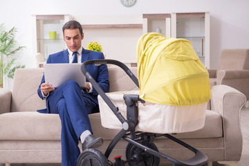 Young businessman looking after baby