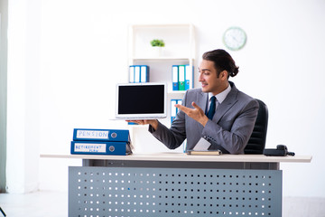 Young male accountant working in the office
