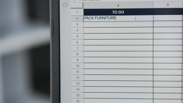 Person marking task PACK FURNITURE in online plan, to-do list