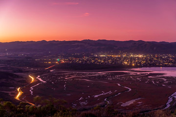 Fototapeta premium Magenta Sunrise over Estuary, City, Roadway, Highway