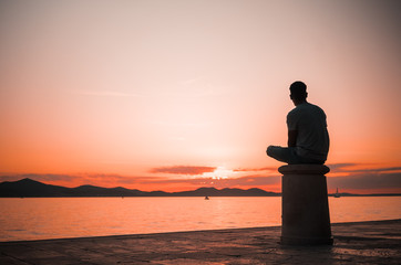 Silhouette of man on the beach, with sunset in Zadar, Croatia
