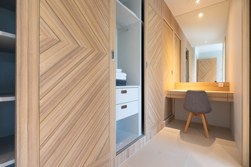 built in wooden wardrobe with working table and chair in bedroom - Powered by Adobe