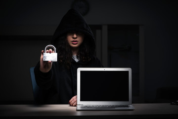 Female hacker hacking security firewall late in office