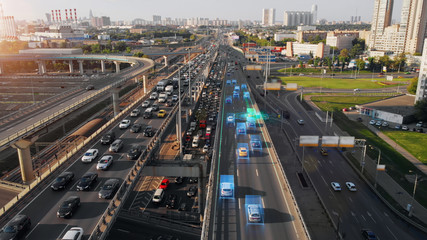 Beautiful aerial presentation of the autonomous cars self-driving concept on multi-level highway in Moscow. Picturesque aerial panorama of the road traffic in a big city on the evening.