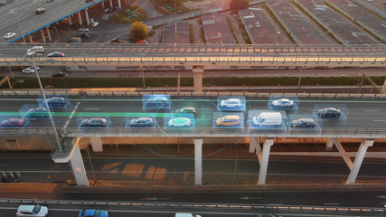 Beautiful aerial presentation of self-driving cars concept on multi-level highway in Moscow. Picturesque aerial panorama of autonomous cars in the road traffic of big city on the evening.