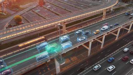Beautiful aerial presentation of self-driving cars concept on multi-level highway in Moscow. Picturesque aerial panorama of autonomous cars in the road traffic of big city on the evening.