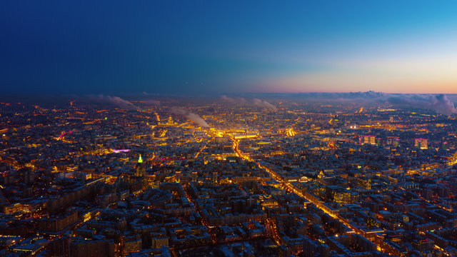 Beautiful Aerial View To Moscow City On The Sunset. Picturesque Motion Of The Evening Metropolis With Street And Building Lights Gradually Turning On And Colorful Sky On The Background.