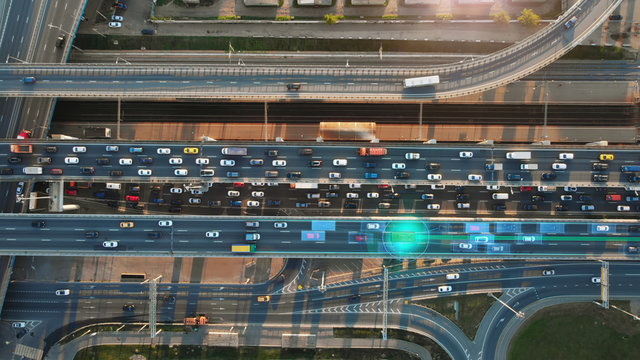Beautiful top view to autonomous cars self-driving on multi-level highway in Moscow. Picturesque aerial panorama of the road traffic in a big city on the evening.