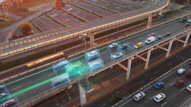 Beautiful aerial presentation of self-driving cars concept on multi-level highway in Moscow. Picturesque aerial panorama of autonomous cars in the road traffic of big city on the evening.