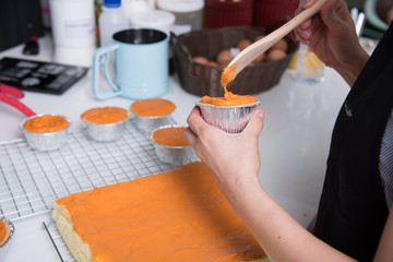 Woman during making decorating cooking bakery cake