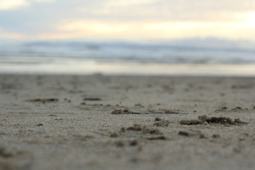 Fototapeta na wymiar Sand on a beach with ocean in background