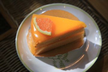 Passion fruit cake, mousse dessert on a white plate. 