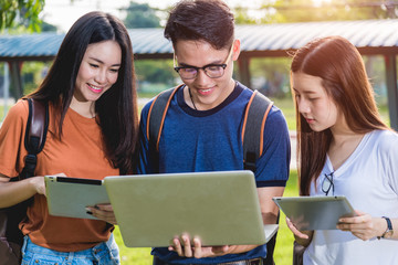 Young Man and classmates, student hold laptop