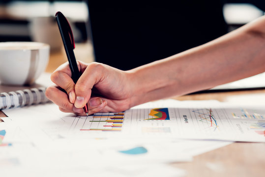 Lifestyle freelance woman and laptop computer he examined the graph profit docume