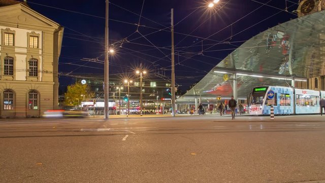 Timelapse. City traffic panorama. View towards central railroad station at night. Bahnhofplatz. Bern. Switzerland. Europe.