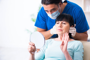 Old woman visiting male doctor for plastic surgery