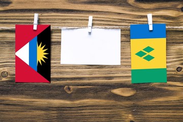 Hanging flags of Antigua and Barbuda and Saint Vincent And The Grenadines attached to rope with...