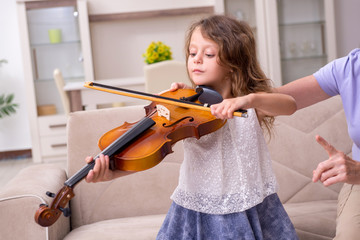 Old lady teaching little girl to play violin © Elnur
