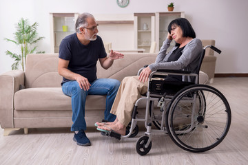 Old husband looking after disabled wife