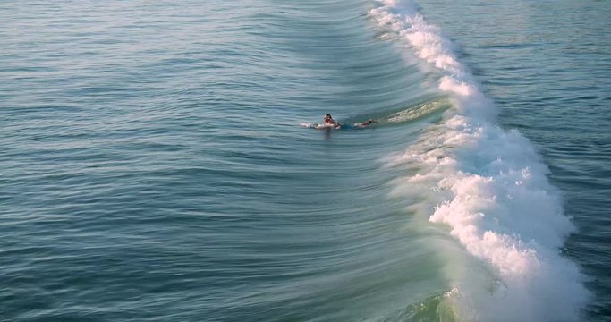 Surfer ducking under wave crash