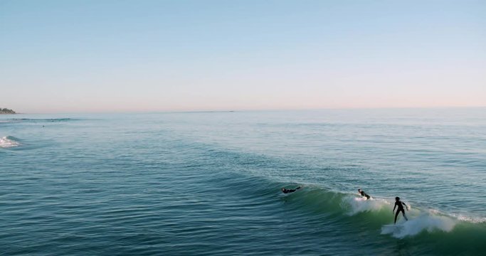 Surfer catching wave and failing