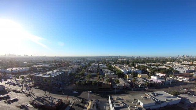 Dolly Left Above Blue Skies & Sunset Boulevard Traffic Facing Downtown Los Angeles & Century City in Hollywood, California 4K
