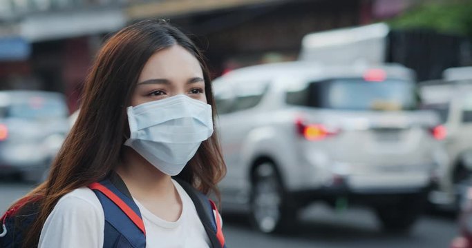 wearing a face mask on the polluted street