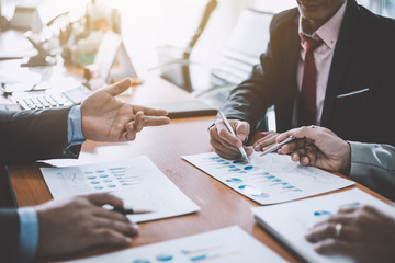 Business people discussion and summary financial information at meeting.