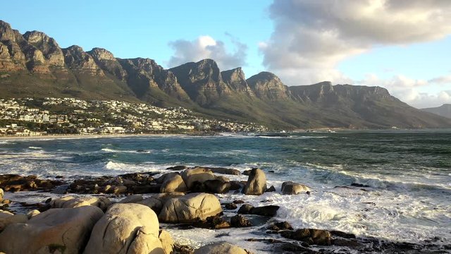 Cinematic Pull Away Shot of Cape Town's Camps Bay Beach with Table Mountain in the Background at Sunset