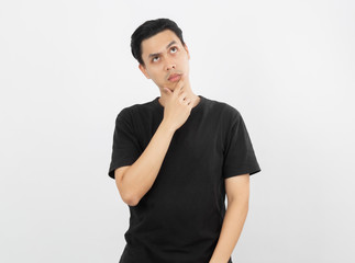 Young asian man with black shirt having doubts and with confuse face expression while scratching head on isolated on white background.