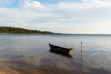amazon river beach with boat at anchor.