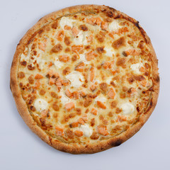 Pizza with salmon and cheese isolated on a white background. Close-up. Top view.