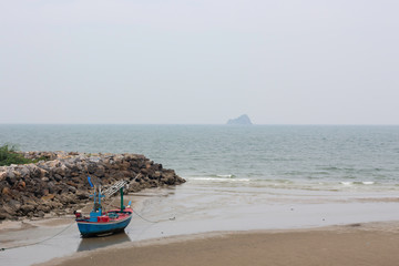 Fishing boats are parked on the beach by the sea
