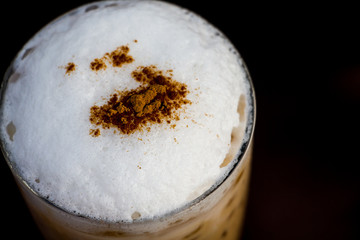 Close up cappuccino foam, Iced coffee on dark background.