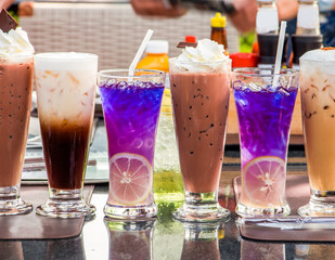 Set colorful cocktails on the table in restaurant. coffee,chocolate,blueberry,tea.