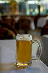 Glass of beer on table in bar, on a table, selective focus and lots of copy space