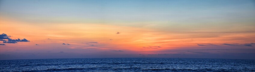 Obraz premium Phuket beach sunset, colorful cloudy twilight sky reflecting on the sand gazing at the Indian Ocean, Thailand, Asia.