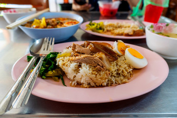 Stewed pork leg and egg with rice and vegetable with spicy sour sauce