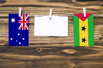 Hanging flags of Australia and Sao Tome And Principe attached to rope with clothes pins with copy...