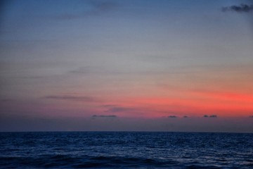 Obraz premium Phuket beach sunset, colorful cloudy twilight sky reflecting on the sand gazing at the Indian Ocean, Thailand, Asia.