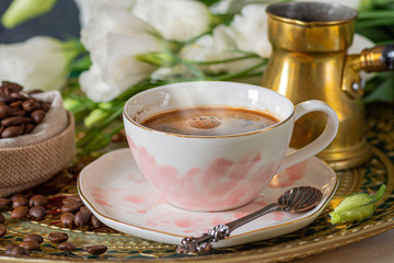 Coffee cup and beans close up .