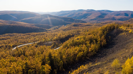 Top view of the taiga forest, river, road . The vast expanses of Eastern Siberia. far East Russia