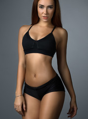 Fototapeta na wymiar Pretty fitness trainer in black top and short