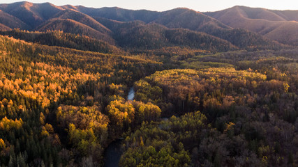 Top view of the taiga forest, river, road . The vast expanses of Eastern Siberia. far East Russia