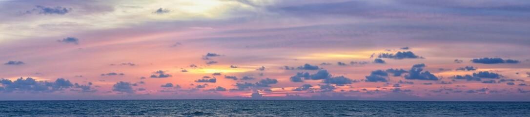 Naklejka na ściany i meble Phuket beach sunset, colorful cloudy twilight sky reflecting on the sand gazing at the Indian Ocean, Thailand, Asia.