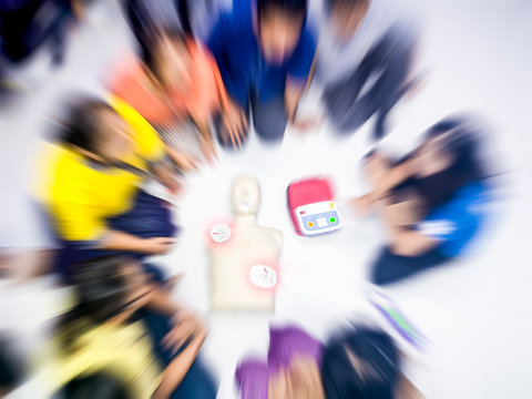 Education healthcare first aid of CPR training medical procedure, demonstrating chest compression on CPR doll ,emergency training for safe life use automated external defibrillator(AED). Zoom effect.