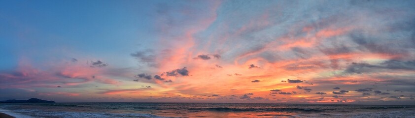 Phuket beach sunset, colorful cloudy twilight sky reflecting on the sand gazing at the Indian...
