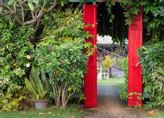 Feel fresh when walk to red door with trees wall.
