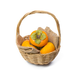 Persimmon in the basket isolated on white background